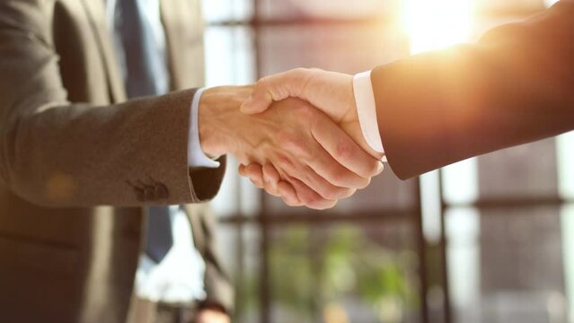 Business shaking hands, finishing up meeting. Successful businessmen handshaking after good deal.