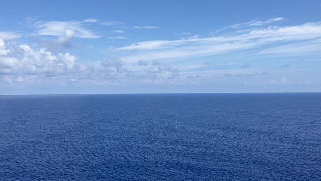 Beautiful scene of calm blue sea with blue cloudy sky