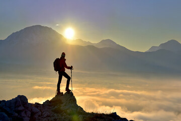 silhouette of a person on a mountain top