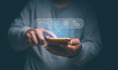 Customer support hotline people connect or contact us, Businessman holding smartphone with icon live chat, email, telephone and address. Concept of using mobile app technology to contact customers.