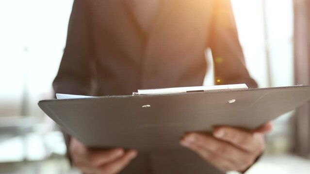 Black leather business padfolio portfolio folder held by man in business suit