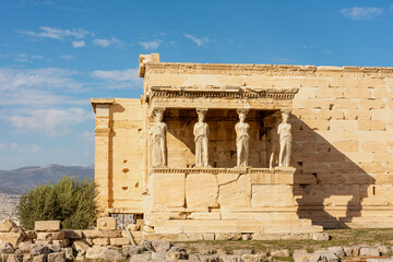 Obraz premium Erechtheion, Erechtheum - ancient Greek temple on Acropolis Athens hill, Greece with the Porch of the Maidens (Caryatid Porch) sculptures
