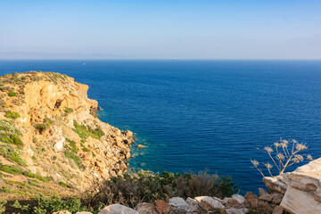 Cape Sounion in Attica, Greece, turquoise Aegean Sea, horizon line, waves and rocks