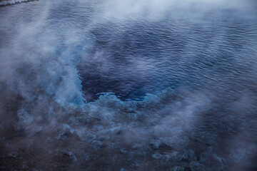 Photo of an icy sea with a hot spring geyser inside