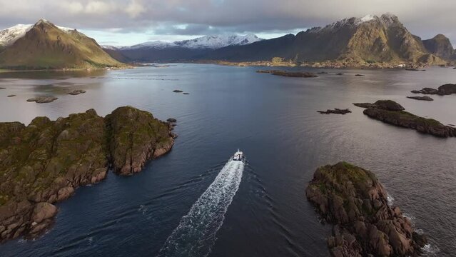 Scandinavian Seafaring Adventure: Aerial Drone Follows a Traditional Fishing Boat Embarking on a Picturesque Day