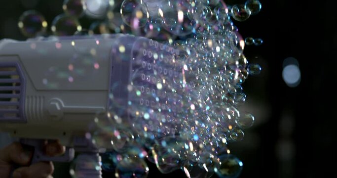Toy gun blowing thousands of soap bubbles in super slow-motion captured with high-speed camera at 800 fps