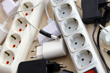Many electrical plugs network congestion. The concept of electrical dependence. Lots of power plugs...