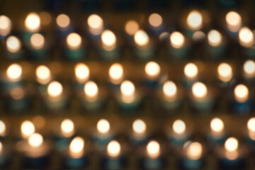 abstract bokeh pattern of candlelight from prayer candles