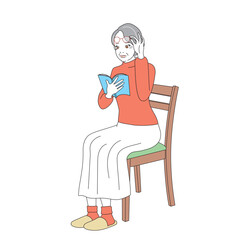 椅子に腰掛け読書をする上品なシニア女性