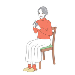椅子に腰掛けスマートフォンを操作する上品なシニア女性
