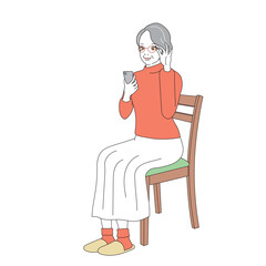 椅子に腰掛けスマートフォンを操作する上品なシニア女性
