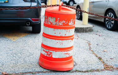 orange construction cones line the urban street, symbolizing safety, progress, and urban...