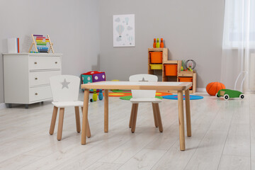 Spacious playroom with furniture and toys in kindergarten