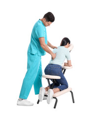 Woman receiving massage in modern chair on white background