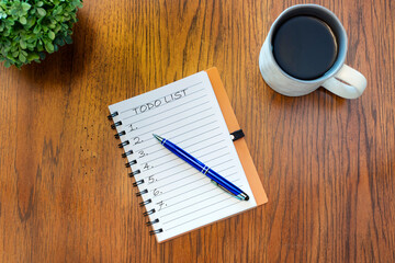 open notepad with pen with cup of coffee.