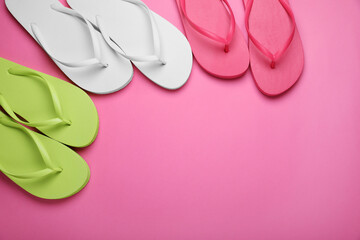 Different stylish flip flops on pink background, flat lay. Space for text