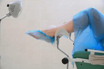 Gynecological checkup. Woman lying on examination chair in clinic, closeup - obrazy, fototapety, plakaty