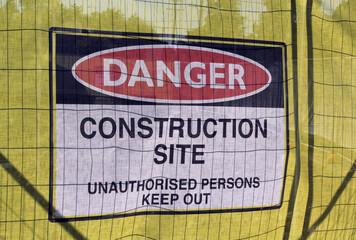 Danger Construction Site sign attached to a fence