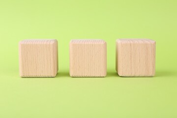 International Organization for Standardization. Wooden cubes with abbreviation ISO on light green background