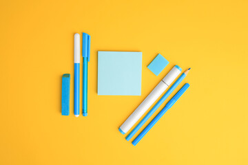 Obraz premium Flat lay composition with different school stationery on yellow background, space for text. Back to school