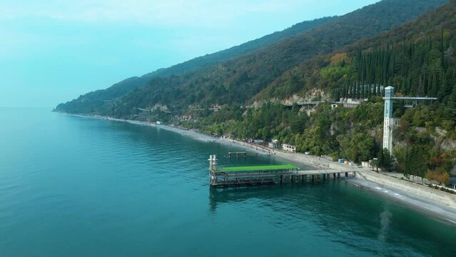 the coastline of the resort town of Gagra in Abkhazia in 2023 , a beautiful view from the sea to the shore , video shooting from a drone. High quality 4k footage