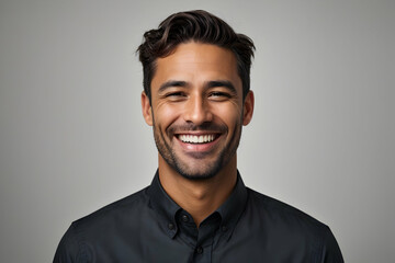 Portrait of happy young businessman smiling at camera against white background