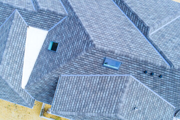 Construction roof of new house is being covered asphalt shingles while building © ungvar