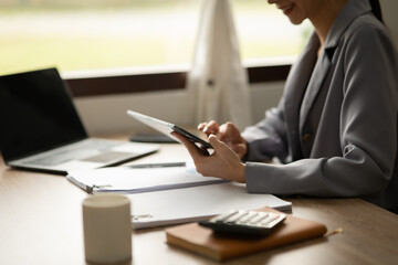 Fototapeta premium Asian businesswoman holding notebook about business, spending money