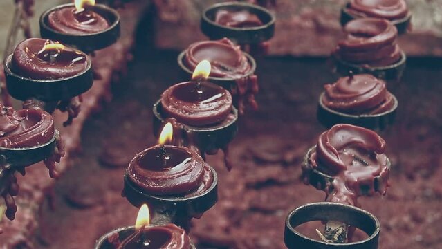 Ambient motion of lit candle offerings during the Lent or Lenten Season, a solemn Christian religious observance in the Philippines