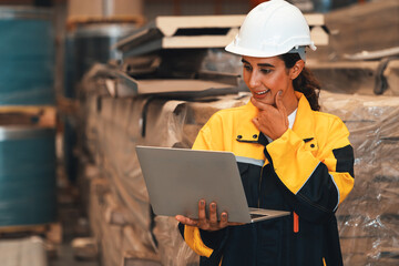 Female engineer or factory inspector conduct inventory check and quality control for metal steel material, contributing in heavy industrial output optimization and manufacturing safety. Exemplifying