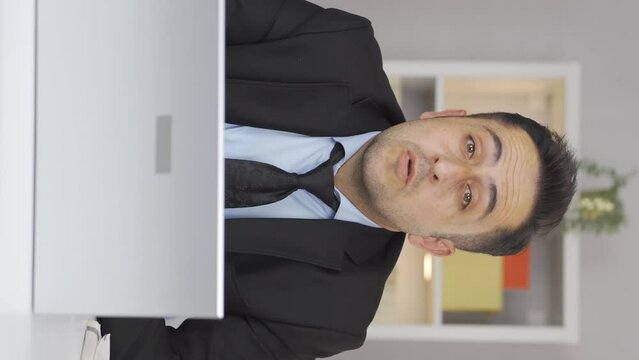Vertical video of Home office worker man nods to the camera, says no, no.
