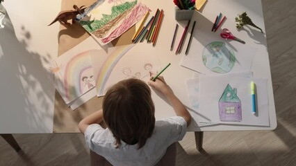 Top view close-up, creative little boy child drawing his family on paper. Family idyll. The concept of happy childhood in happy family. Smart kid draws himself with mom and dad holding hands. Adoption - Powered by Adobe