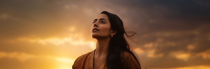 Indian woman looking at sunset sky