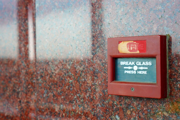 The words break the glass press here on the alarm