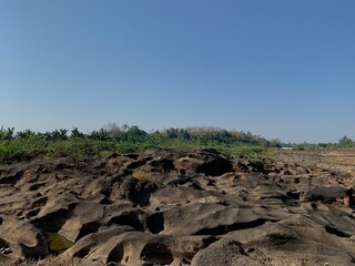 Obraz premium The view of the water in the dam during the dry season with its rocks is very beautiful