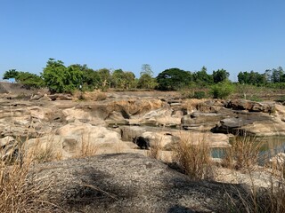 The view of the water in the dam during the dry season with its rocks is very beautiful