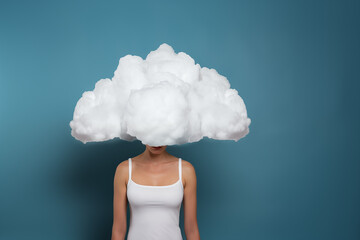 sad woman with cloud over face and head, isolated on plain blue studio background