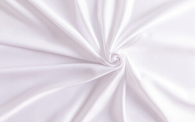 Chic white wedding background in white satin with soft spiral pleats. delicate folds of fabric. A copy of the space. design. layout. template.