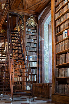 Old books on shelves in imperial national library in Hofburg, Vienna, Austria