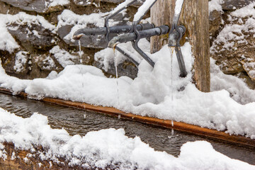 open outdoor faucet in winter , murren , switzerland - 673062680