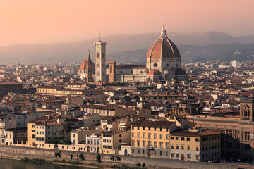 Sunset cityscape of old town with giant Duomo cathedral dominating above rooftops, Florence, Italy