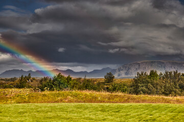 rainbow over the mountains - 673077883