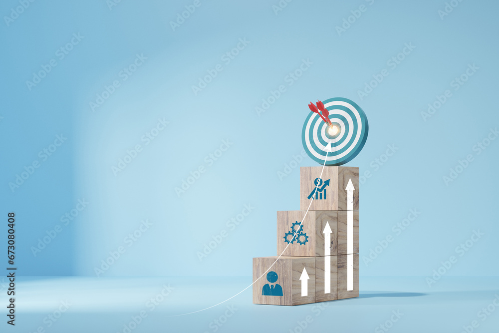 Wall mural woods block step on table with icon action plan. target icon on the top of wooden cube blocks. shini