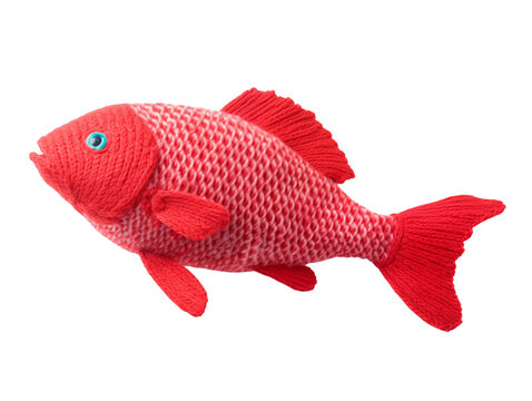 Knitted toy red fish with a white border on the scales. Isolated on a transparent background.