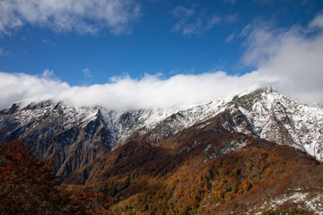 View of Mount Tanigawa with Autumn leaves and snow, Gunma, Japan