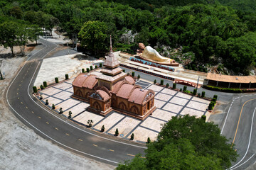 Sandstone castle and large outdoor reclining Buddha at Tham Phu Wa Temple It is a Thai art form. It...