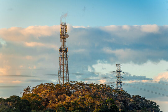 Mobile tower and power lines installation, cell site and telecom base station. 5G internet online generation.