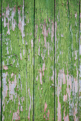 Close view of a deteriorated aged green painted wooden structure