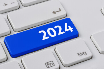 A keyboard with a blue button - 2024