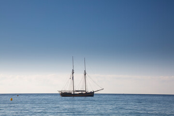Fototapeta premium Wooden boat with two masts at anchor